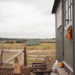 Little Girl walking to gate from Family Hut