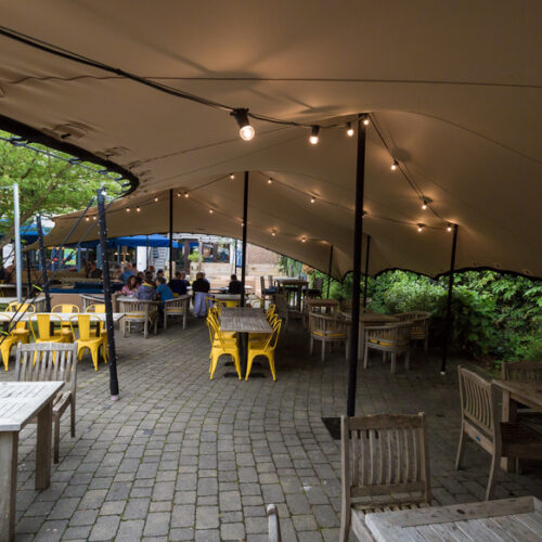 Outdoor lighting festoons the bespoke stretch tent at The Spitfire Kings Hill
