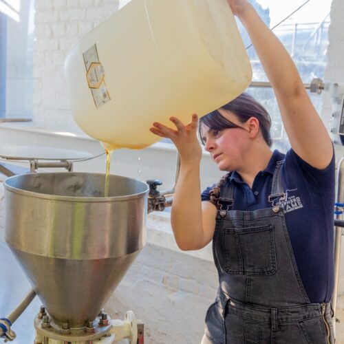 Shepherd Neames Technical Brewer Danielle Whelan pours the Paynes Bee Farm honey into the brew Sq